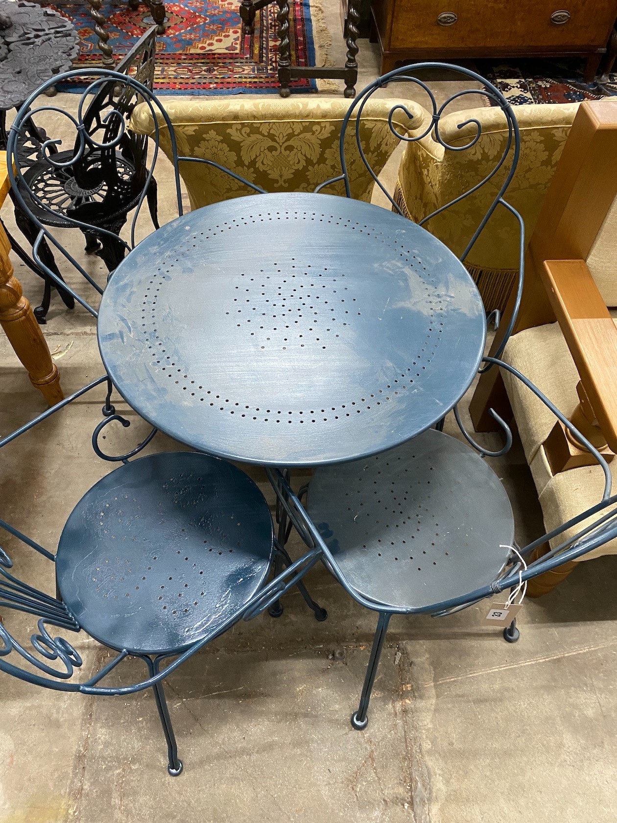 A circular painted aluminium garden table, diameter 70cm, height 72cm and four chairs